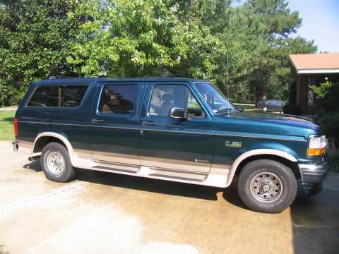 1995 Ford C-150 (Centurion Conversions) - This SUV, likely a 1992 model, is dark green with a tan lower body and running boards.