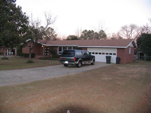 1995 Ford C-150 (Centurion Conversions) - Dark blue 1995 Ford C-150 Centurion Conversions SUV parked in a suburban driveway.