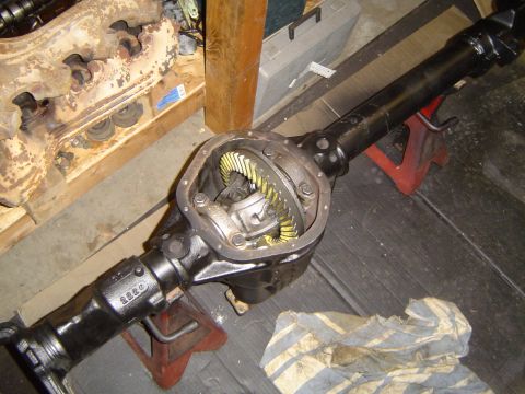 1989 Ford Bronco - The differential assembly is exposed, showing the internal gears. A rag lies on the floor nearby.