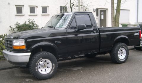 2003 Jeep TJ - This black 1992 Ford F-150 pickup truck is shown from a 3q-front angle.