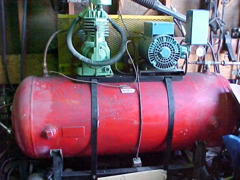 1973 Ford Ranchero - Horizontal red-tank air compressor in a shop, with a green two-cylinder cast-iron pump, teal electric motor, pressure gauge and regulator,…