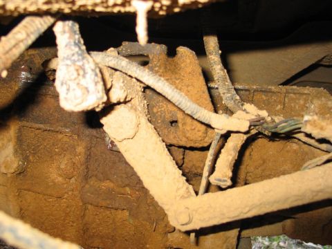 1995 Ford Bronco - Undercarriage view shows heavily soiled mechanical linkages and electrical wiring.