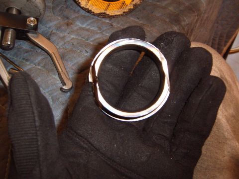1988 Ford Bronco - A gloved hand holds a metal ring, with tools and a grinding disc in the background.