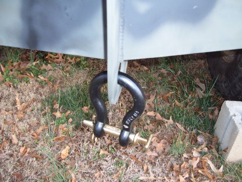 1988 Ford Bronco - A heavy-duty tow shackle is secured to the vehicle's frame, ready for towing or recovery operations.