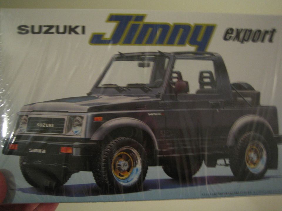 Box art of a dark Suzuki Jimny with 'export' text