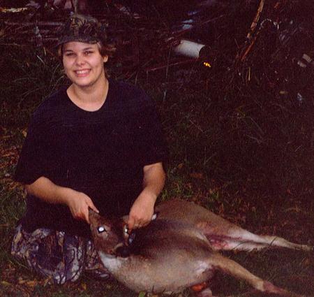 1985 Ford Bronco - A hunter proudly displays her catch in an outdoor setting.