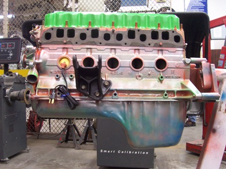 1988 Jeep Cherokee - Jeep 4.0L inline-6 engine on a stand, possibly undergoing testing or rebuild.
