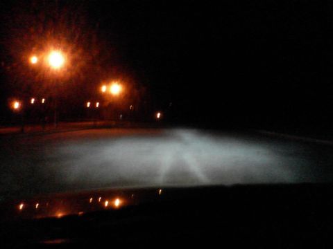 2000 Dodge Durango - Headlights cut through fog on a dark road at night, with reflections visible on the dashboard.