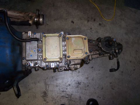 1967 Ford Mustang - Transmission assembly shown on a concrete floor, likely a component from a vehicle.