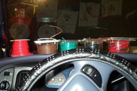 1998 Ford Crown Victoria - The wiring that will be snaked through the side of the dash. Note the coathanger coming up through the dash.