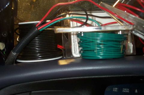1998 Ford Crown Victoria - Spools of wire are visible on the interior dashboard, with some text on a package indicating it was supplied by NAPA.