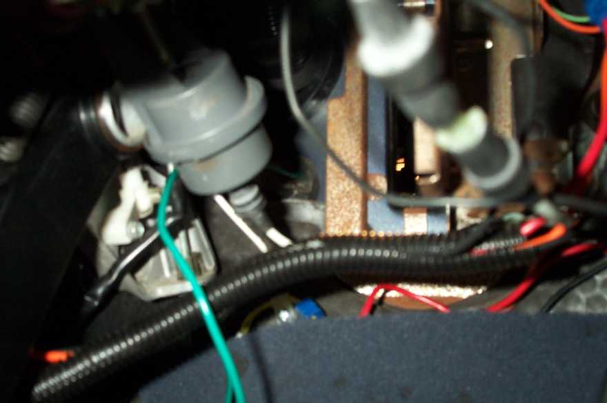The green wire is the tach wire, running through a grommet into the firewall.

It's blurry but you get the idea.