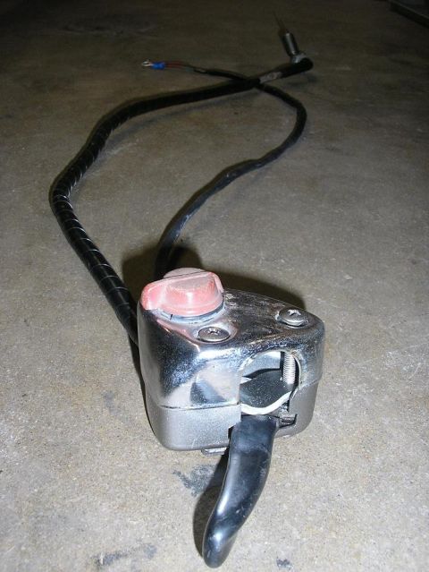 1900 Honda Big Red - A motorcycle handlebar switch assembly with wiring is shown on a concrete floor.