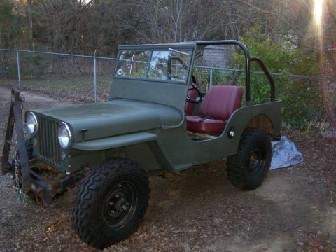1993 Ford Bronco - This vintage Jeep features a utilitarian design with its doors removed and a simple roll bar for protection.