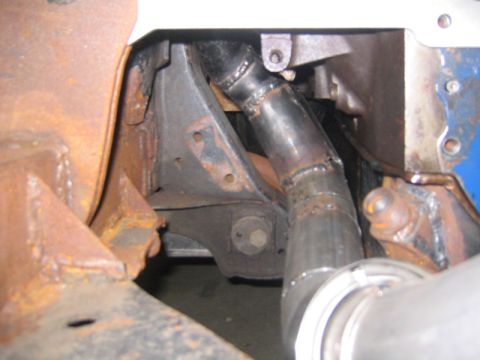 1969 Ford Mustang - Close-up view of rusty chassis parts and a custom exhaust pipe, with a Supermotors.net watermark.
