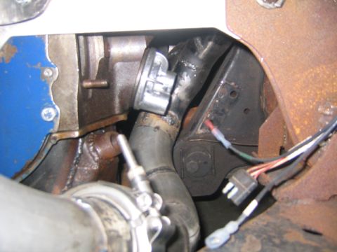 1969 Ford Mustang - Close-up view of turbocharger plumbing and associated wiring.