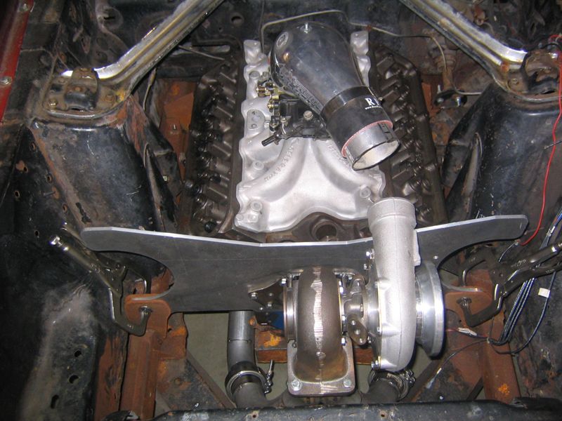 1969 Ford Mustang engine bay with turbocharger and intake manifold