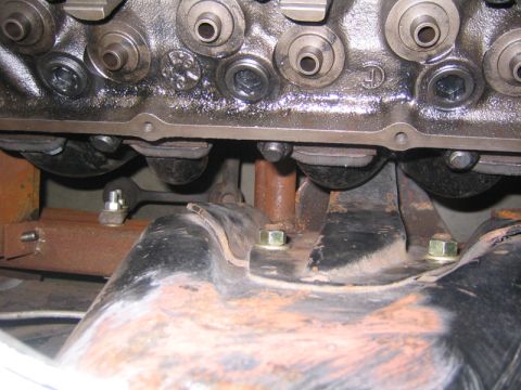 1969 Ford Mustang - Close-up of an engine block, showing mechanical components and mounting hardware.