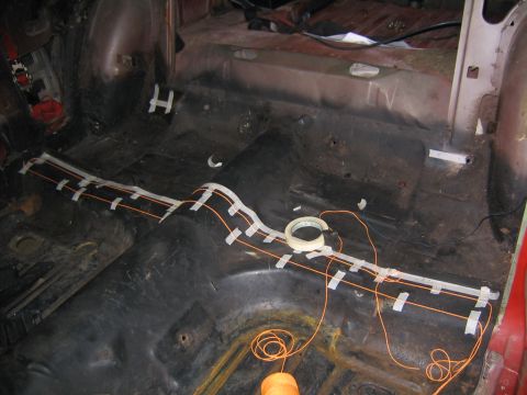 1969 Ford Mustang - The interior of a car shows wiring being laid out on the floor, likely for a turbo build project.