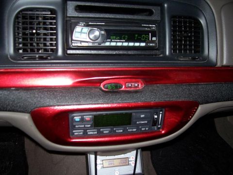 1999 Ford Crown Victoria - The interior dashboard features a digital clock and aftermarket audio equipment.