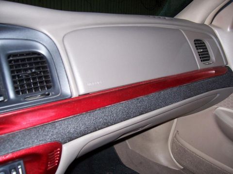 1999 Ford Crown Victoria - Dashboard interior of a 1999 Ford Crown Victoria, showing air vents and red trim accents.