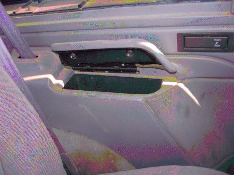 1981 Ford F-150 - Close-up of a vehicle's interior door panel and armrest assembly.