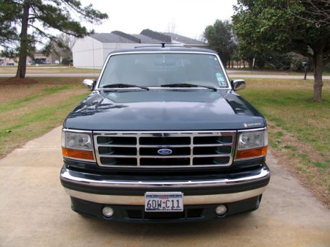 1995 Ford C-150 (Centurion Conversions) - This Ford truck features a prominent chrome grille and a "Centurion" badge, indicating a custom conversion.