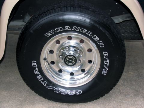 1995 Ford C-150 (Centurion Conversions) - A close-up view of a Goodyear Wrangler RT/S tire mounted on a polished chrome wheel.