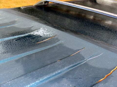 1995 Ford C-150 (Centurion Conversions) - Scratches and rust are visible on the dark roof of this vehicle, which has a roof rack.