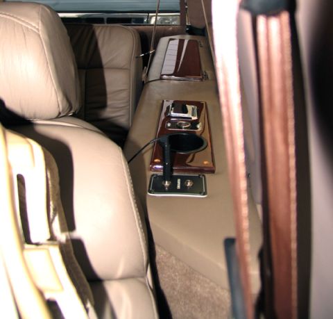 1995 Ford C-150 (Centurion Conversions) - The interior console features a cup holder and several switches, suggesting a custom conversion.