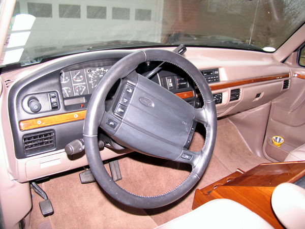 1995 Ford C-150 Centurion Conversions interior with wood trim and tan dashboard