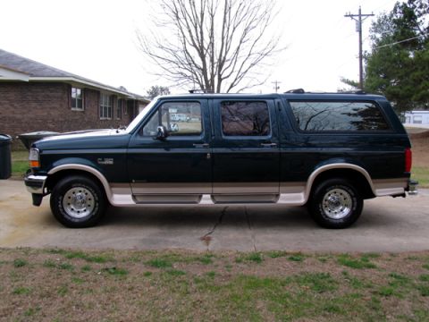 1995 Ford C-150 (Centurion Conversions) - Side profile of a 1995 Ford C-150 Centurion Conversions SUV parked on a driveway.