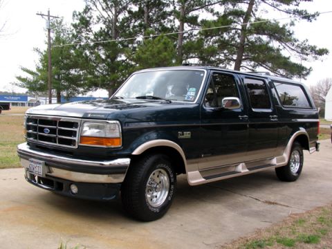 1995 Ford C-150 (Centurion Conversions) - This Ford Bronco Centurion conversion van has a distinctive two-tone paint scheme and appears to be from the early to mid-1990s.