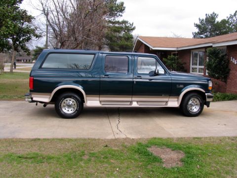1995 Ford C-150 (Centurion Conversions) - Side view of a 1995 Ford Bronco with tan two-tone paint and running boards.