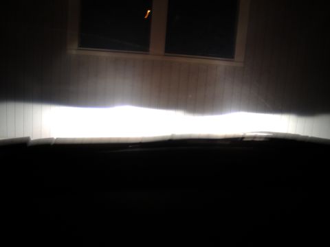 1998 Ford Taurus - View from inside a vehicle as headlights illuminate a wall.