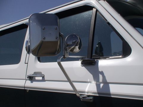 1993 Ford C-350 (Centurion Conversions) - Towing mirror assembly on a white truck, focus on the mirror and its mounting bracket.