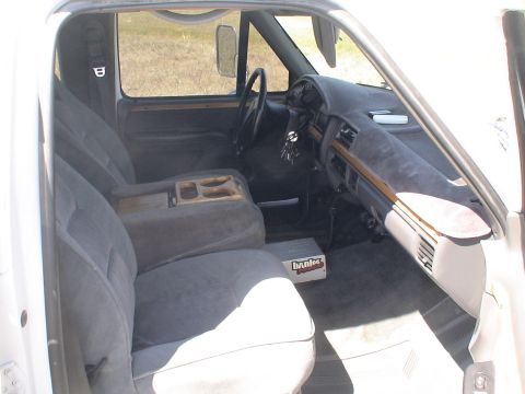 1993 Ford C-350 (Centurion Conversions) - Interior view of a 1993 Ford C-350 (Centurion Conversions) truck, highlighting the cab's features.