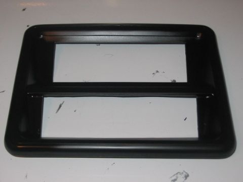1991 Ford Bronco - This is a black plastic trim piece with two rectangular openings, likely for a car stereo or climate controls.