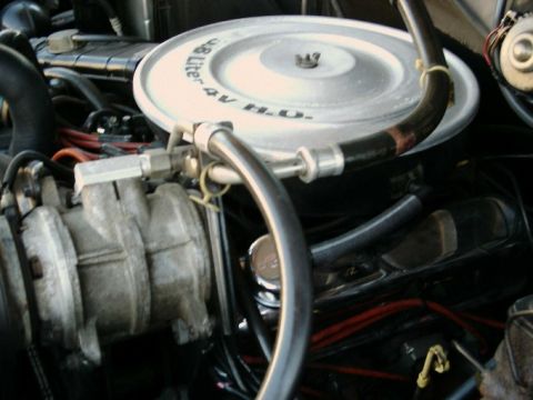 1984 Ford Bronco - Close-up of an engine compartment, focusing on the air cleaner assembly.