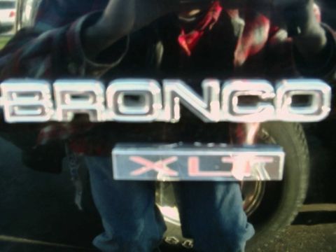 1984 Ford Bronco - The chrome Bronco emblem and XLT trim are visible on the side of the vehicle.