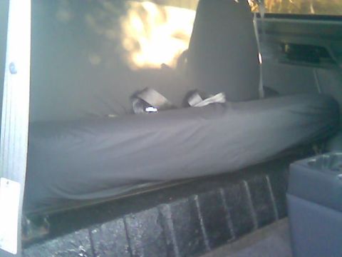1992 Ford Bronco - Interior view of a vehicle's rear seating area with seatbelts visible.