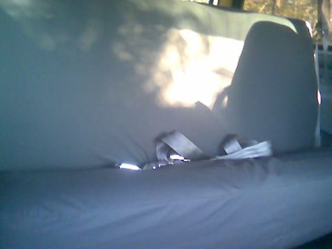 1992 Ford Bronco - The interior of a vehicle is shown, with seatbelts prominently displayed.