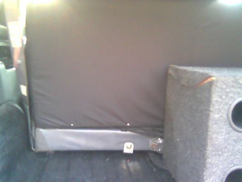 1992 Ford Bronco - Subwoofer box installed in the rear of a vehicle, next to the folded-down seat.