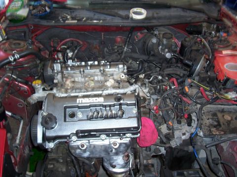 1996 Ford Probe - The engine bay of a car is shown with the engine partially disassembled and various components exposed.