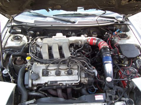 1996 Ford Probe - The engine bay of a car, a V6 intake manifold and custom intake piping.