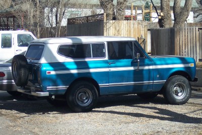1972 Ford Ranchero - This blue and white SUV, possibly an International Harvester Scout, is parked next to a white van.