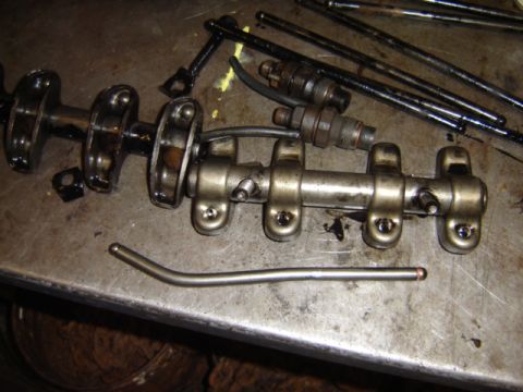 1992 Ford Bronco - Disassembled engine valve train components are laid out on a metal surface.