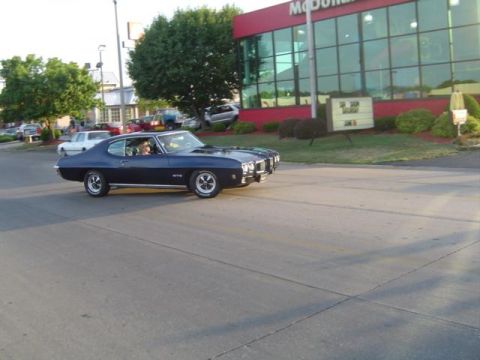 1979 Ford Bronco - A classic Pontiac GTO cruises by a McDonald's restaurant.