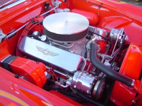 1979 Ford Bronco - Close-up of a red engine bay with chrome accents and a prominent air filter.