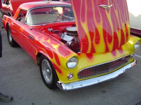 1979 Ford Bronco - Customized 1955 Ford Thunderbird with a vibrant flame paint job and exposed engine.